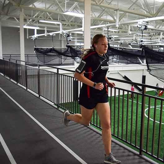 A student running on the Rec Center track